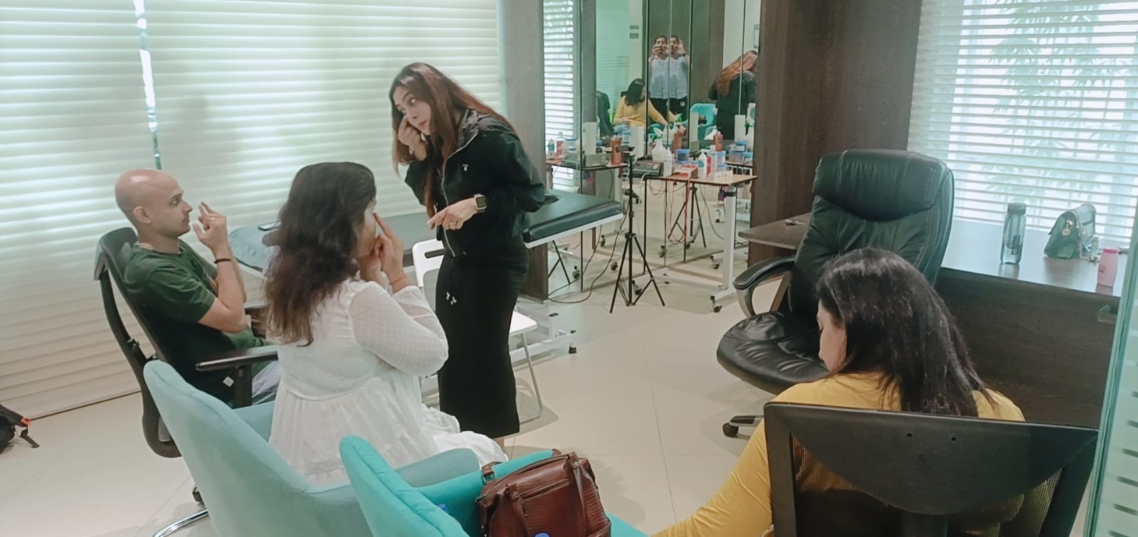 Vibha Jain demonstrating a technique to a small group seated in a consulting room.