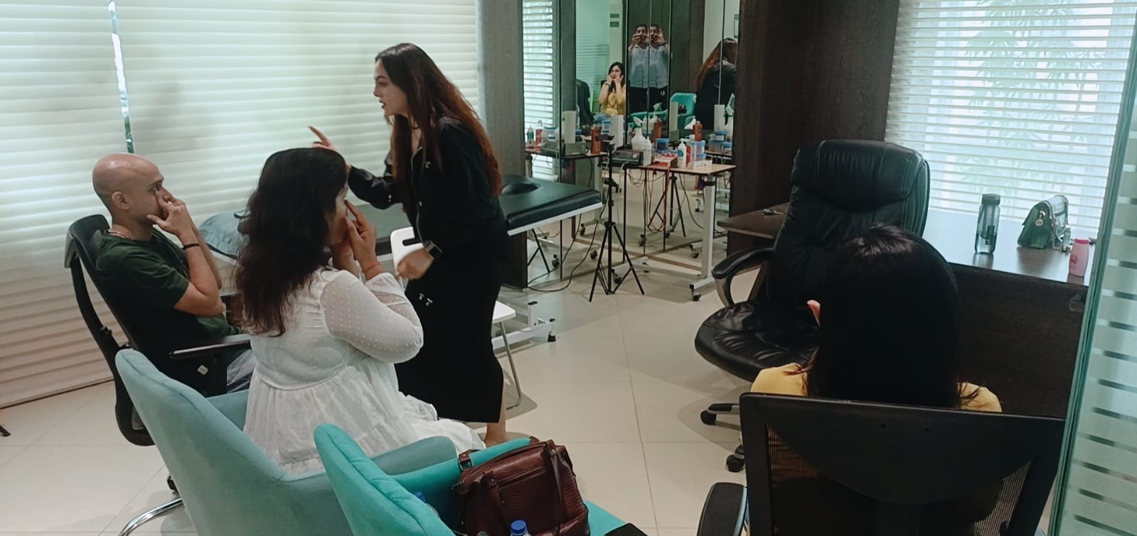 Vibha Jain leading a small group through a relaxation technique in a consulting room.